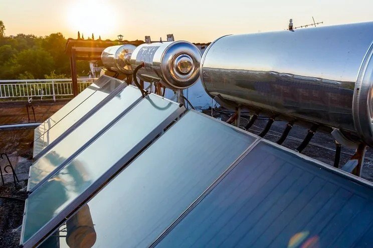 Residential building with rooftop solar water heating collectors